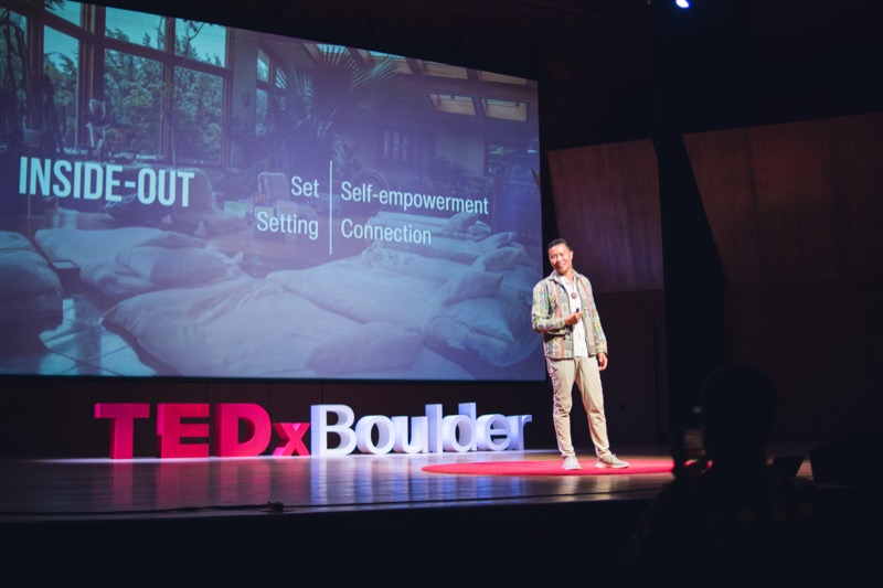 Austin Mao speaking on stage at TEDx Boulder 2024
